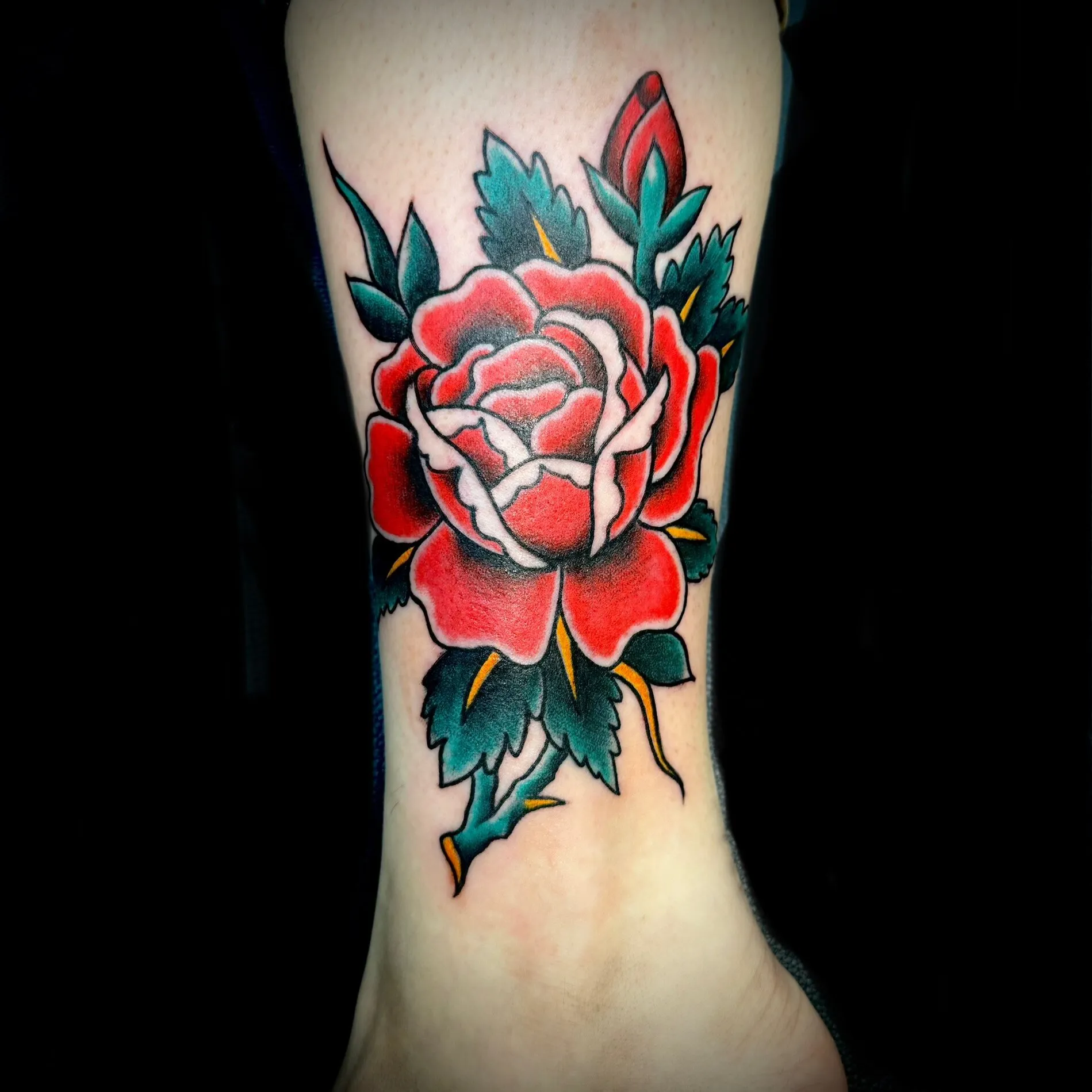 American traditional red rose tattoo with bold black linework by Josh Robinson in Dallas, TX