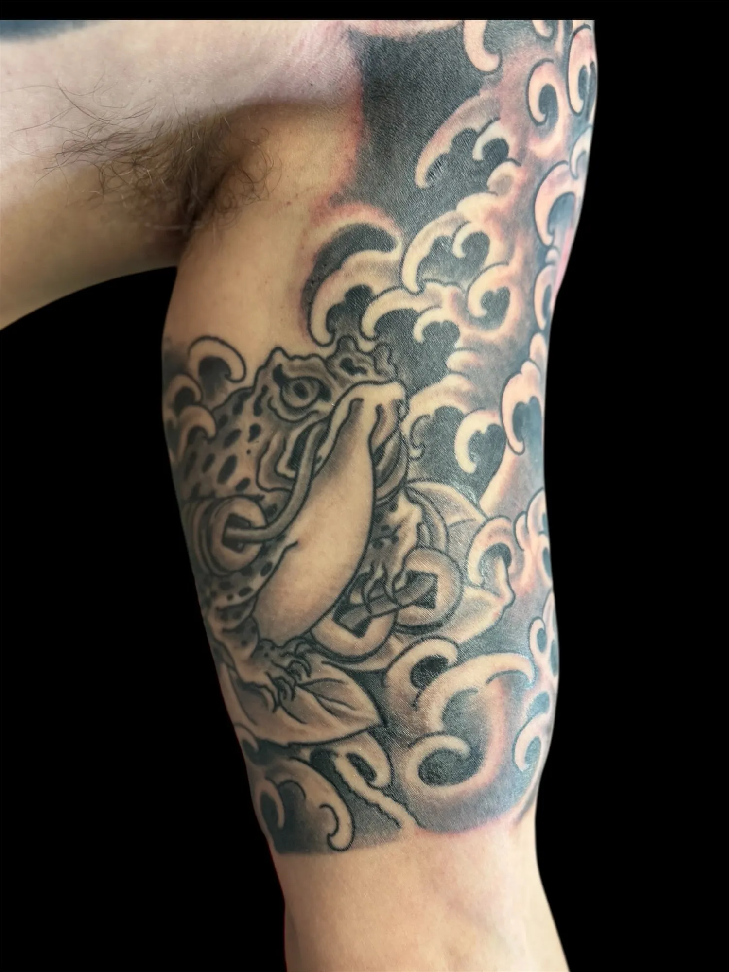 Black and grey Japanese foo dog and waves half sleeve tattoo by Josh Robinson in Dallas, TX