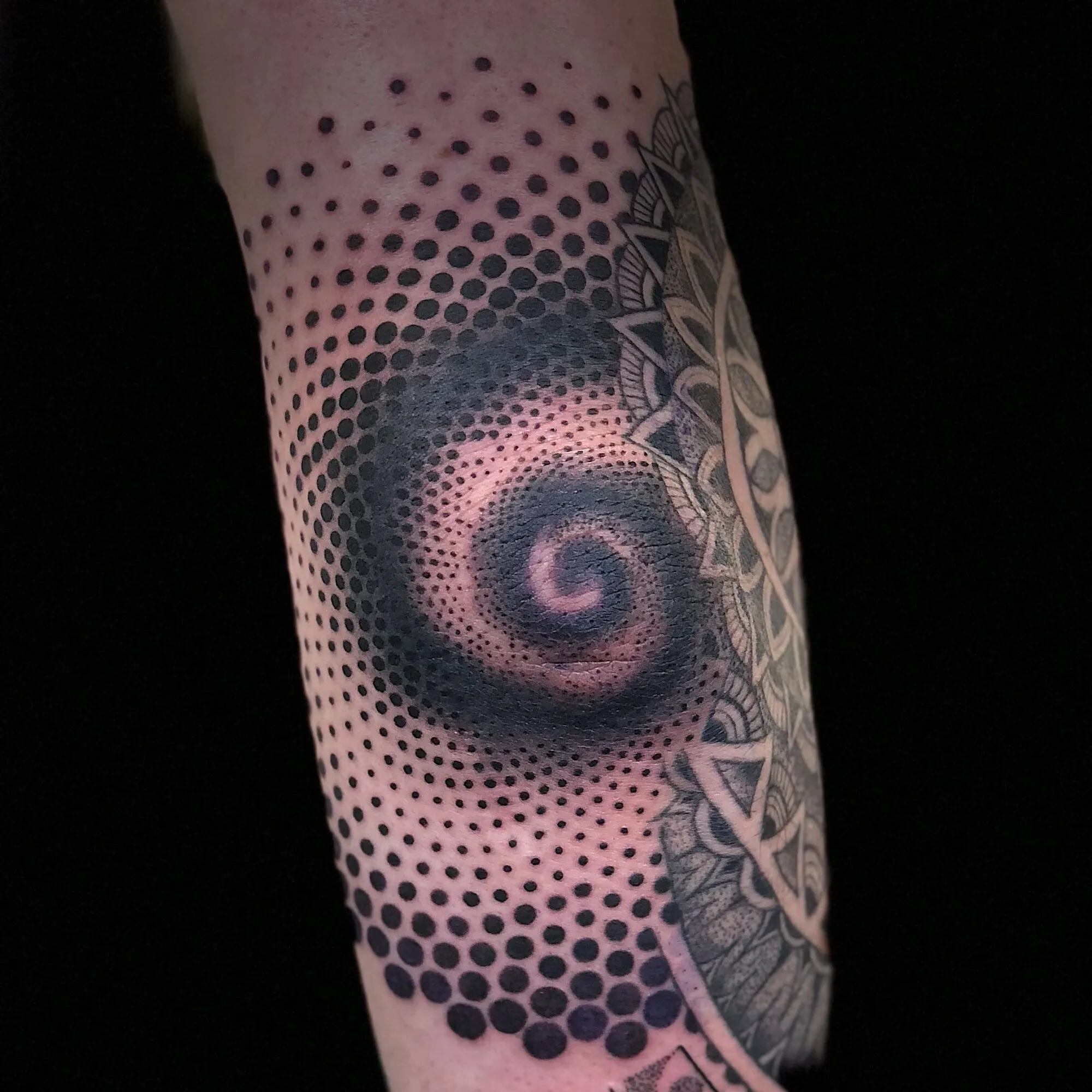 Black and grey dotwork mandala spiral elbow tattoo by Josh Robinson in Dallas, TX