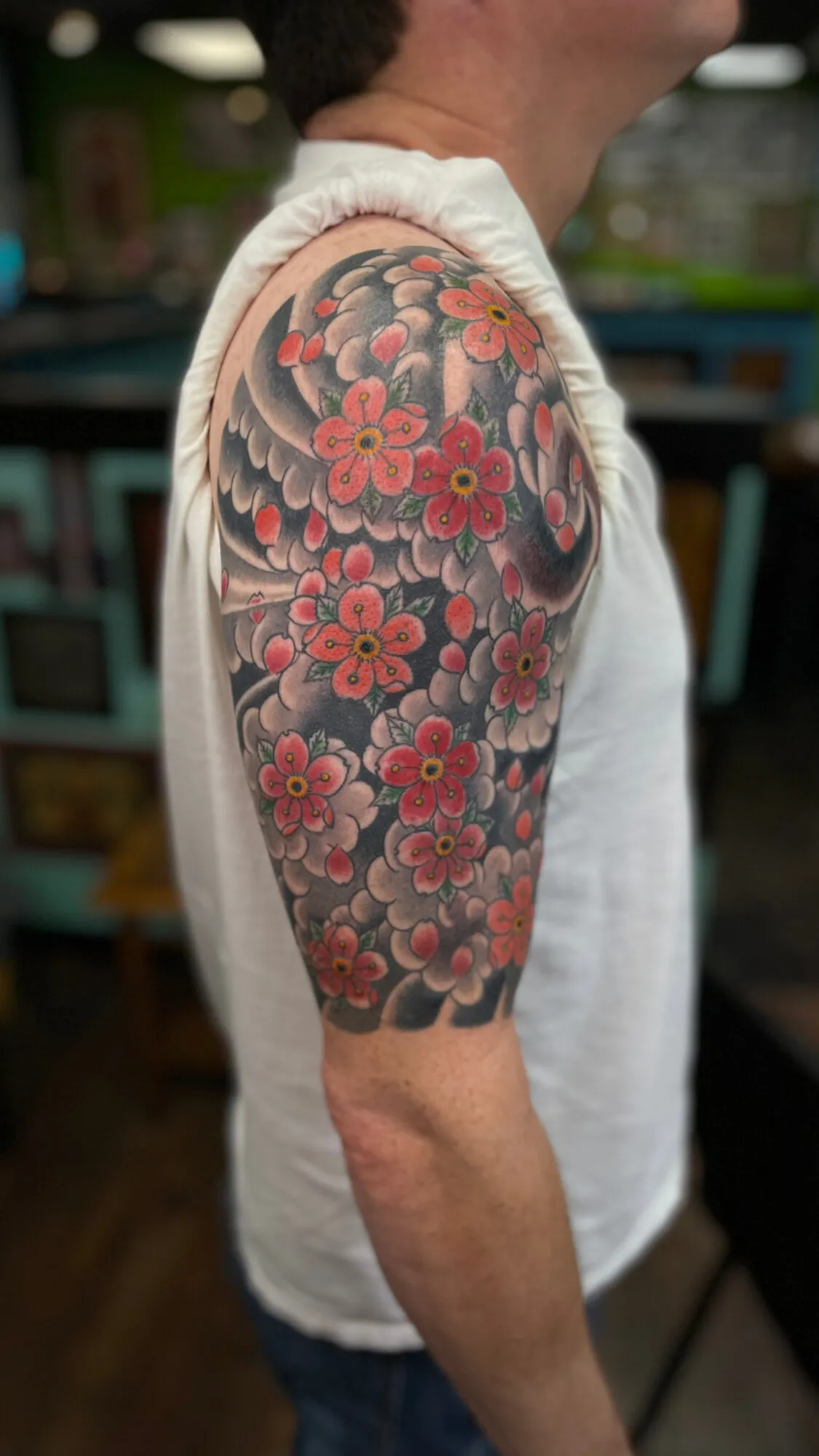 Japanese cherry blossom half sleeve tattoo in red and black by Josh Robinson in Dallas, TX