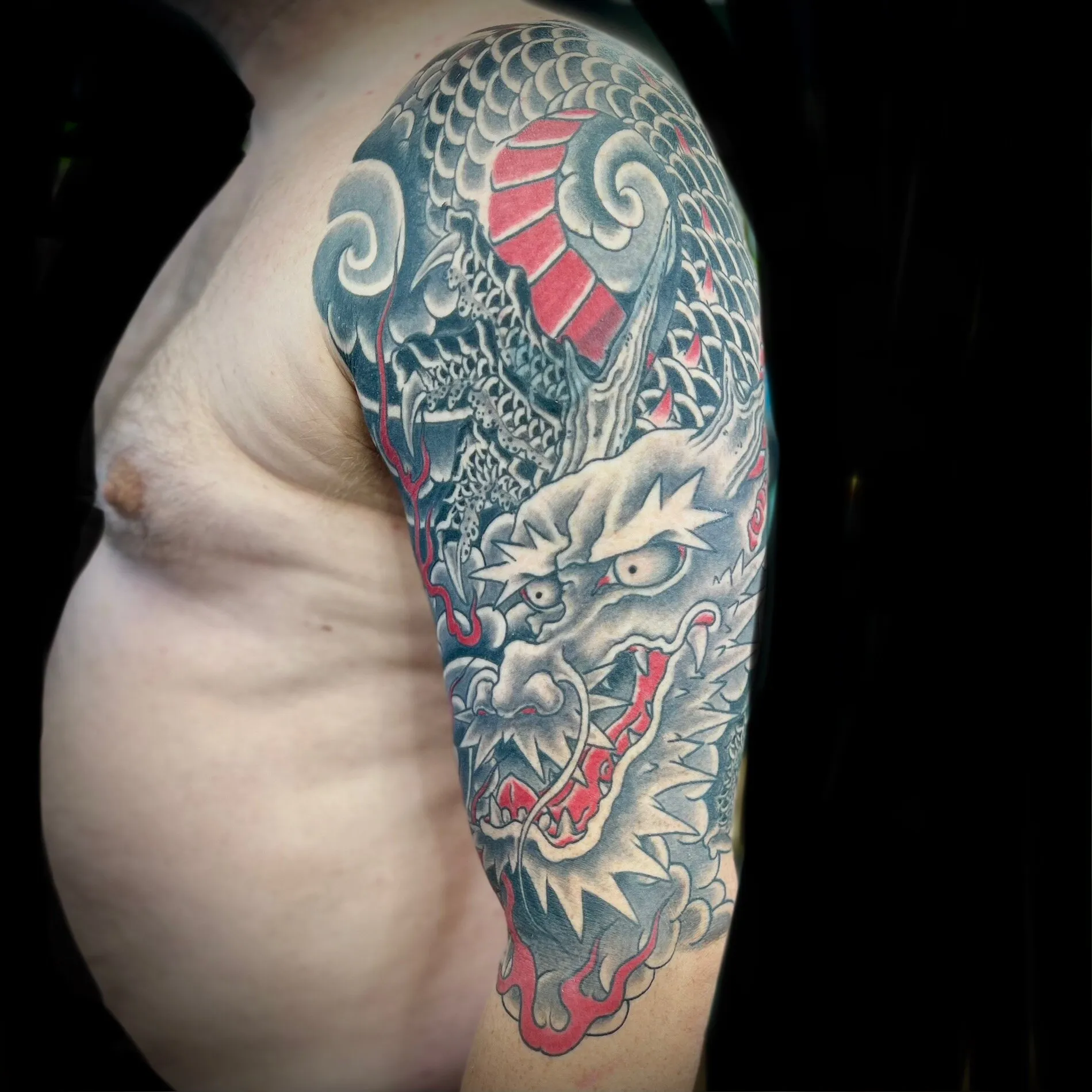Japanese dragon half sleeve tattoo in blue, grey and red by Josh Robinson in Dallas, TX