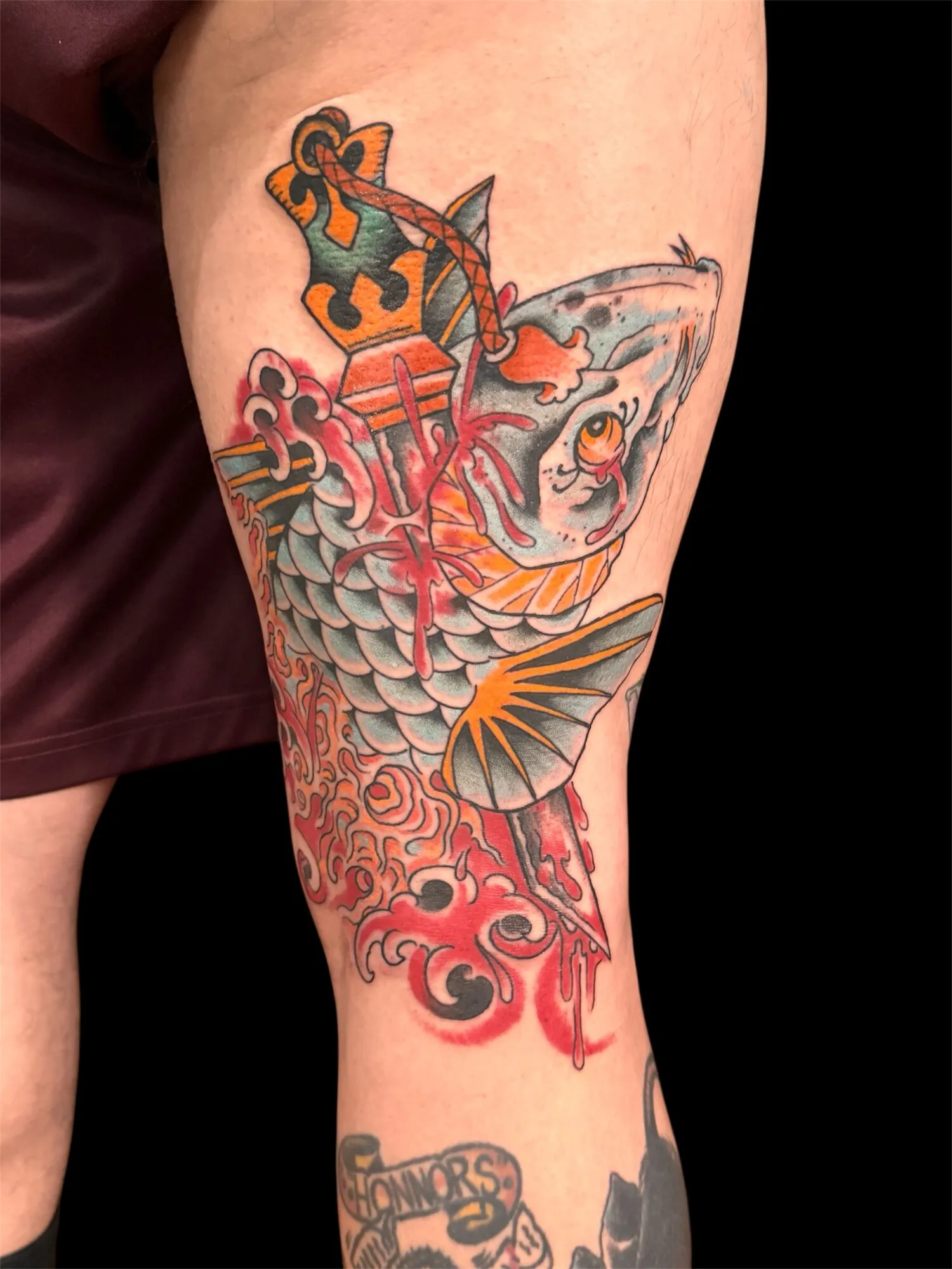 Traditional Japanese koi fish and dagger arm tattoo in red and grey by Josh Robinson in Dallas, TX