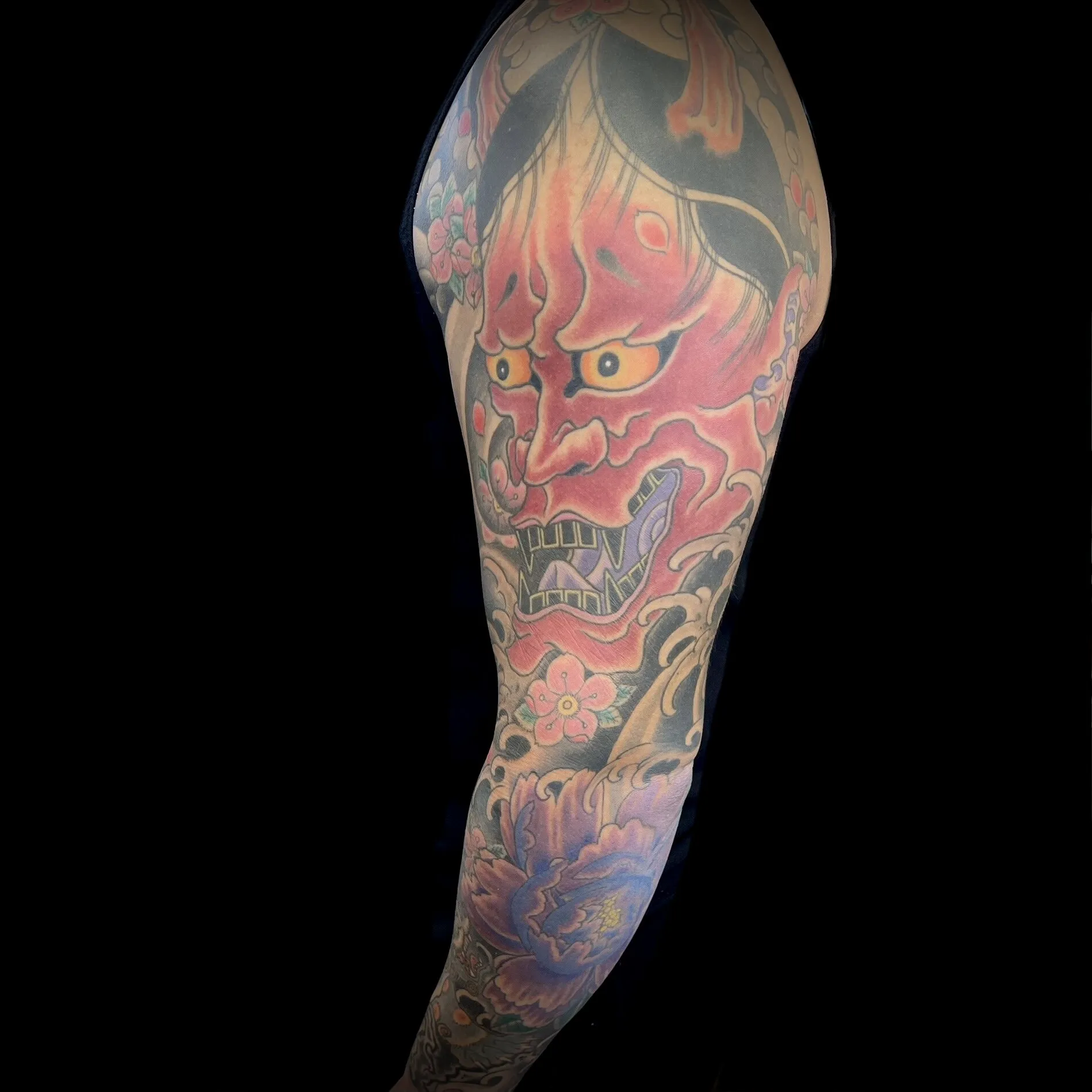 Red Japanese hannya mask full sleeve tattoo with peony and clouds by Josh Robinson in Dallas, TX
