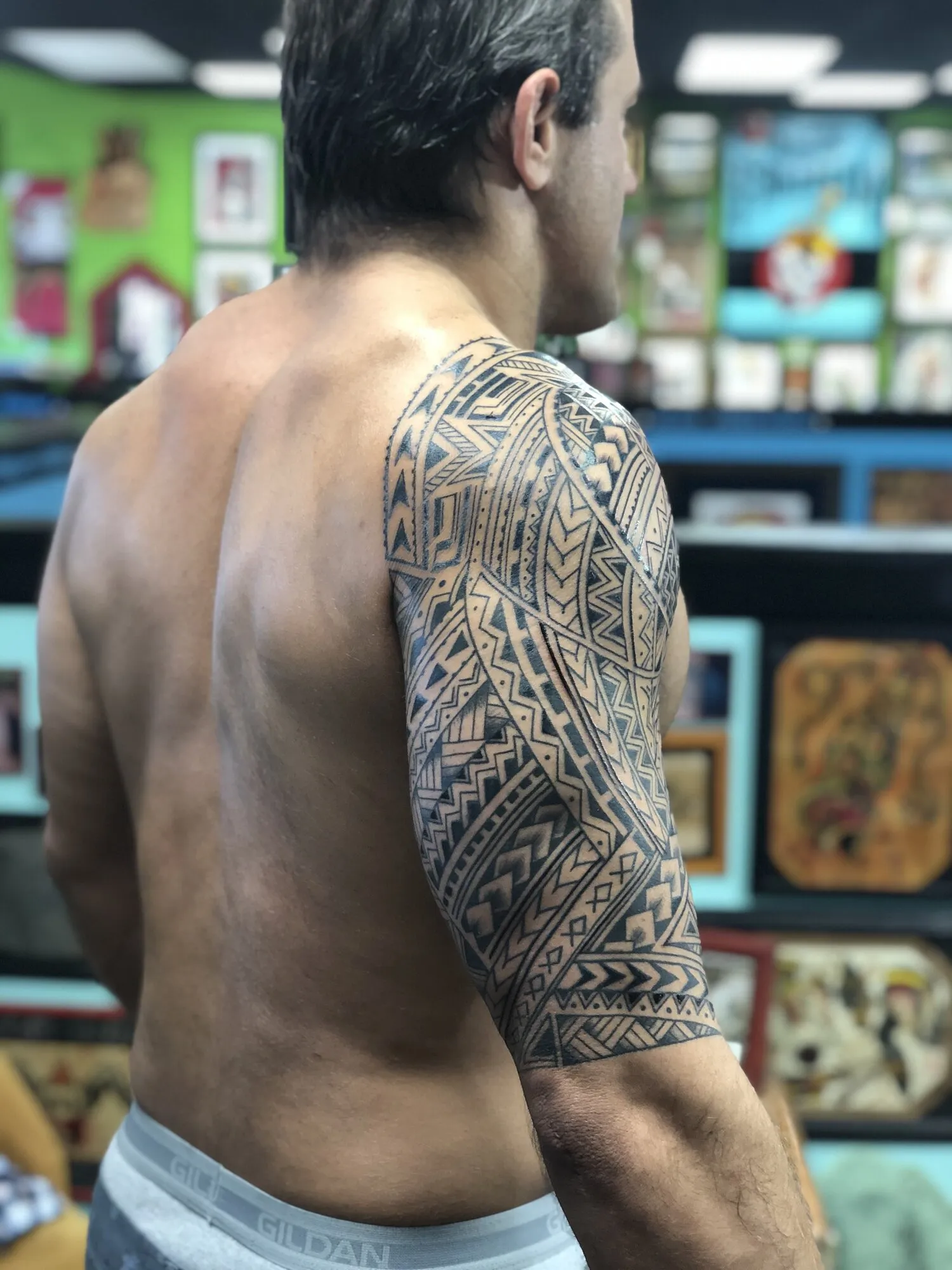 Polynesian tribal half sleeve tattoo seen from behind by Josh Robinson in Dallas, TX