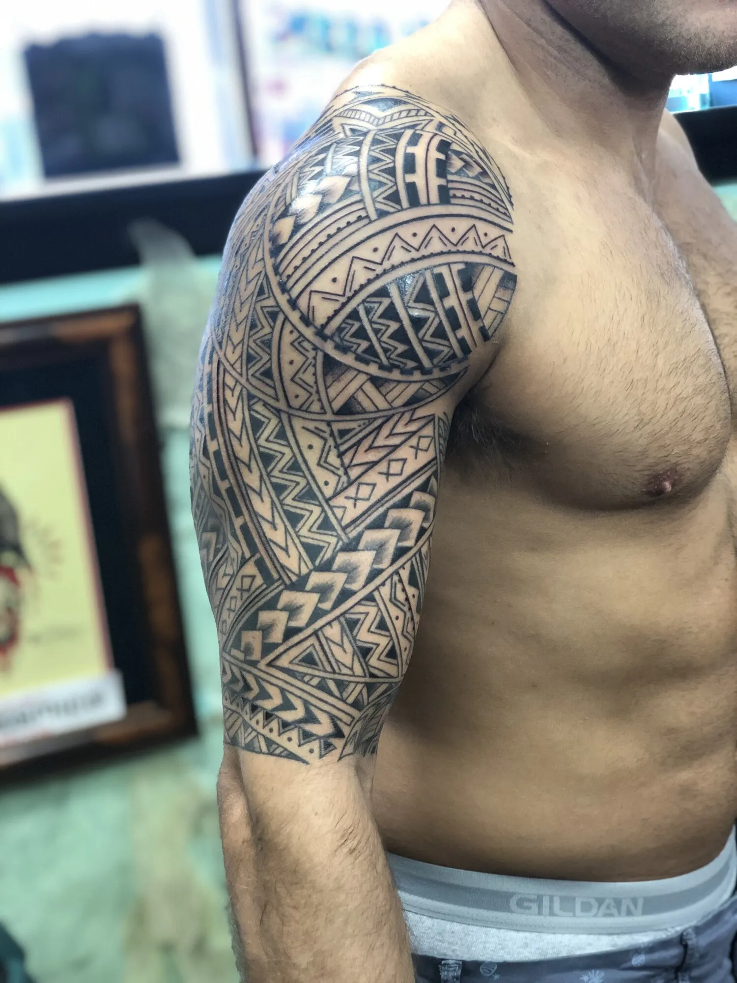Polynesian tribal half sleeve tattoo seen from the side by Josh Robinson in Dallas, TX